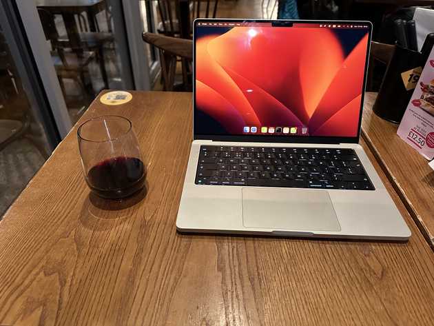 Laptop and wine on a table at GBK